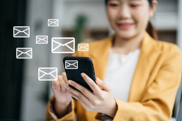 Email notification concept, Female use smartphone and laptop receive message alert in the mailbox.