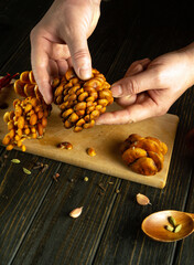 The chef sorts mushrooms with his hands on the kitchen table. Concept of cooking dietary mushrooms...