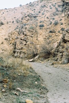 Deserted dirt road in the mountains of Armenia in spring - film photo