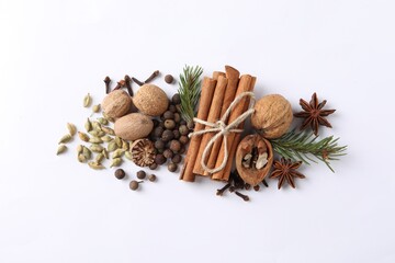 Different spices and fir branches on white table, flat lay