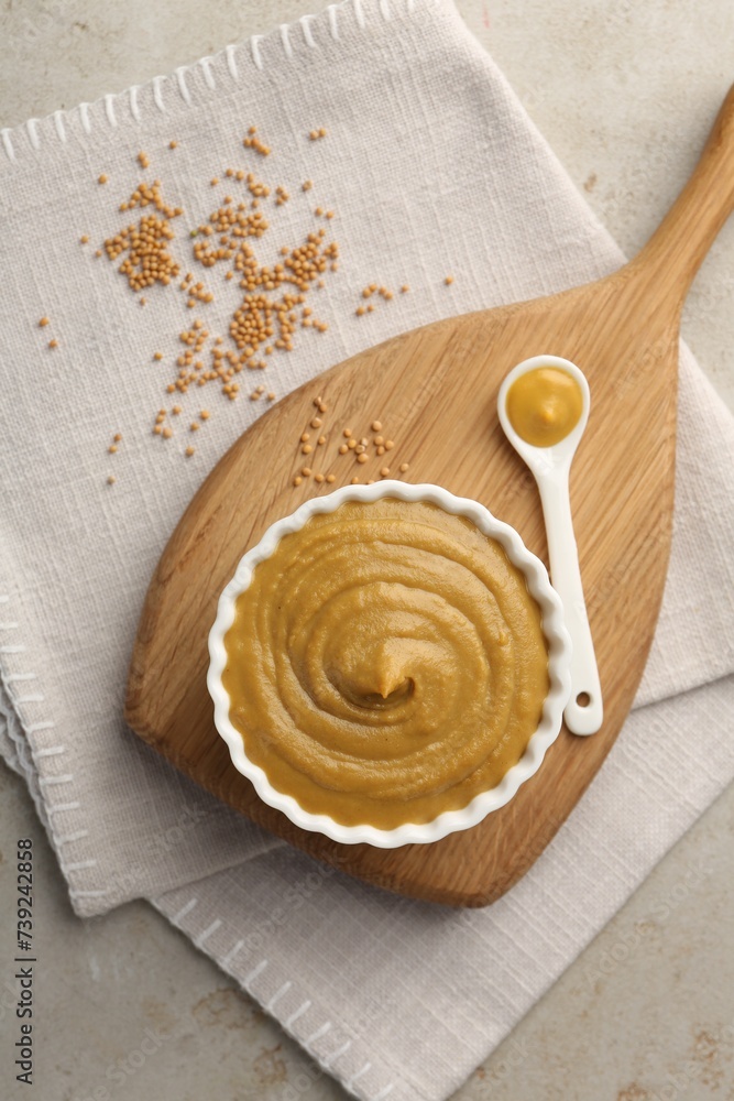 Poster Tasty mustard sauce and dry seeds on light textured table, flat lay