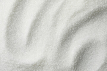 White granulated sugar as background, top view