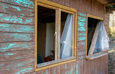 Old wooden gazebo after a break-in with broken windows