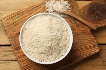 Raw basmati rice on wooden table. flat lay