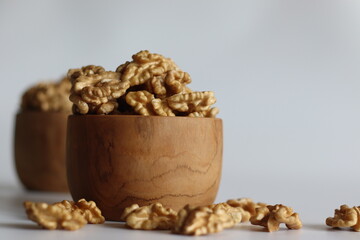 Pristine pile of premium dry walnuts in a wooden bowl, ideal for culinary creations and healthy snacks.