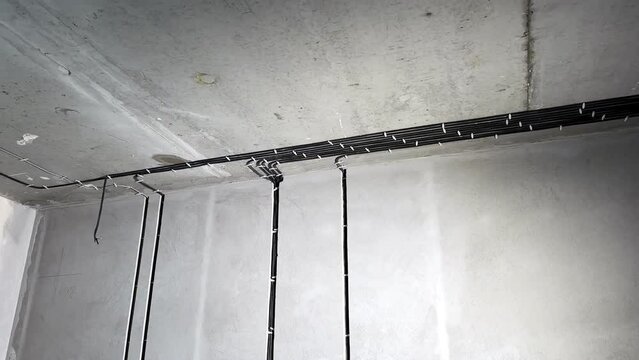 Wires, cables in concrete wall, socket places during rough electricity works, electric repair, apartment renovation