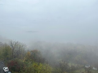 Heavy fog over the forest on an autumn morning. View from above.