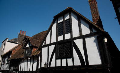 Wooden house roof attics against clear blue sky. Home residential building. Traditional british houses