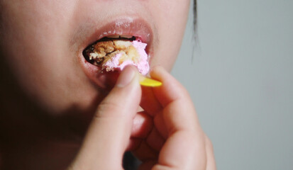 Woman eating cup cake deliciously,