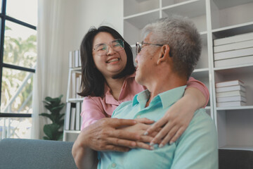 Obraz premium A father and daughter sat in the living room happily spending time together after not seeing each other for a while, A warm family is in the house, Elderly father and teenage daughter