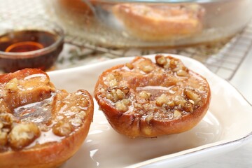 Delicious quinces baked with honey and walnuts on table, closeup
