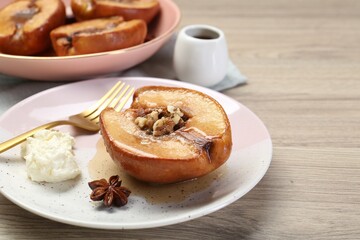 Delicious quince baked with honey and walnuts on wooden table