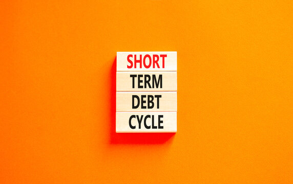 Short term debt cycle symbol. Concept words Short term debt cycle on beautiful wooden block. Beautiful orange table orange background. Business Short term debt cycle concept. Copy space.
