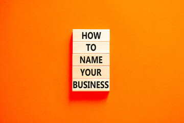 How to name your business symbol. Concept words How to name your business on wooden blocks. Beautiful orange table orange background. How to name your business concept. Copy space.