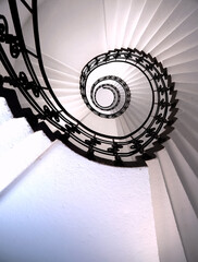 Spiral staircase still life with black ornament railing top view