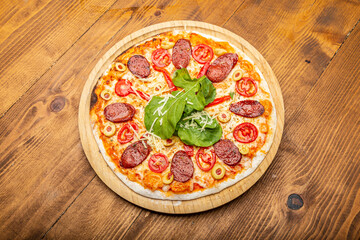 pizza with tomatoes, bacon, salami and mozzarella