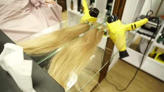 Kyiv, Ukraine - December 22, 2021 - A hairstylist cuts a child's hair. Stylish hairstyle, girl in a hairdresser.