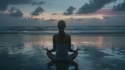 Fototapeta premium Caucasian woman practicing yoga at seashore