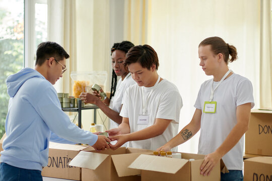 Group of volunteers accepting donations in office of charity organization