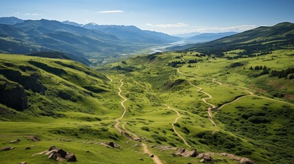Fototapeta na wymiar Aerial view of a winding mountain trail, hikers visible in the distance, lush green valleys and rugged terrain, highlighting the beauty of hiking in the mountai