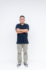 Full body portrait of a serious middle-aged Asian man standing with crossed arms against a white background.