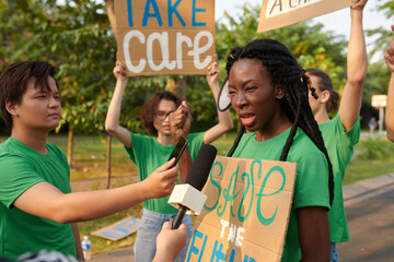 Black girl taking to journalists about eco activism and volunteering