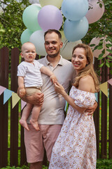  Little boy turns one, celebrating with family love on his special day.