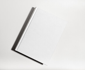 Blank book cover mockup. Clear textbook hardback, catalog lying on table