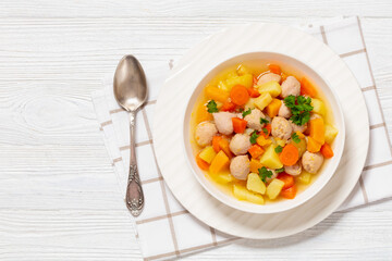 finnish sausage soup with vegetables in white bowl