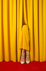 legs of a woman in a dress blending in with the theater curtain.An illusionary portrayal of an actress on stage with a hidden identity.Copy space,top view.Minimal creative art concept