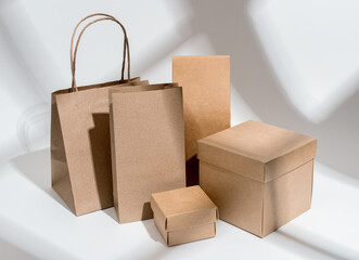 Kraft paper and cardboard packages. Carton packs arrangement, light from window