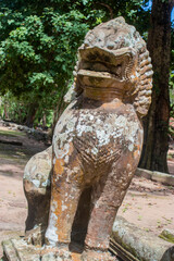 Fototapeta na wymiar Ancient stone statue of the guardian creature in form of a lion at Angkor Thom temple complex in Cambodia