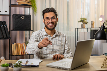 I choose you. Young Arabian businessman programmer software developer working on office laptop...