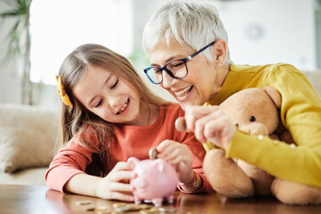 child money saving grandfmother family coin senior finance bank piggybank happy investment granddaughter girl financial elderly cash