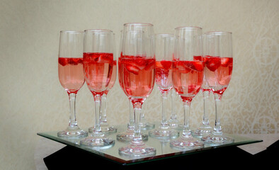 Strawberry splashing into a glass of champagne