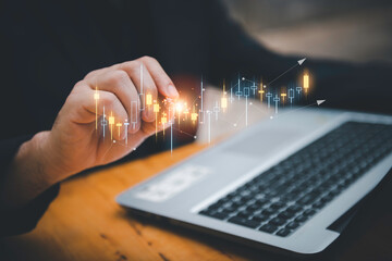 Hand of Businessman or trader is showing a growing virtual hologram stock on smartphone, planning...