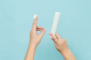Packaging for vitamins, pills with tablet in hand. White tube. Mockup