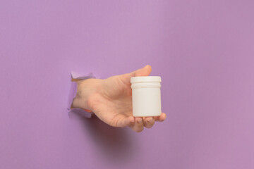 Cosmetic container in female hand. Cosmetic beauty packaging