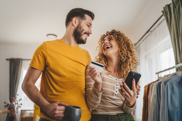 adult happy couple man and woman shopping online hold credit card