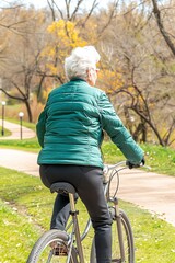 Active Senior Woman Enjoying a Bike Ride in Park