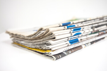 Pile of newspapers isolated on white background. Can be used for illustration or background design.
