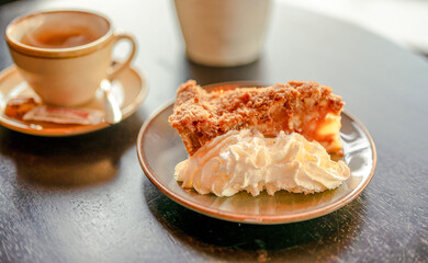 Cup of coffee with a piece of traditional Apple pie