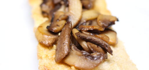 toasted bread with mushrooms. details of mushrooms prepared for meal. food with selective focus.