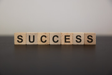 Positive Words Vocabulary concept, SUCCESS word cube wooden with Kalimba and rope roll on the wooden background, start your work day refreshed.