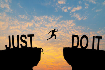 Man jumping on I can do it or I can't do it text over cliff on sunset background, Business concept...