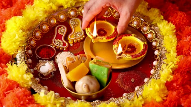 Onam Diwali vishu celebration Indian festival flowers marigold flowerbed lighted oil lamp Nilavilakku Diya colors Rangoli decoration greetings Dipavali Kerala Tamil nadu North India Mumbai Delhi India
