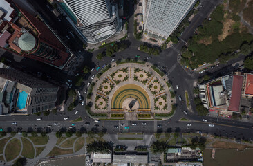 Saigon Vietnam traffic roundabout top down aerial photo. City buildings , park and ferry wharf can be seen. Ho Chi Minh City center on sunny clear day.
