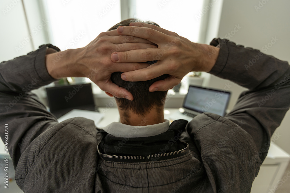 Aufkleber trading stocks online. back view of young businessman or trader working with graph and charts on com