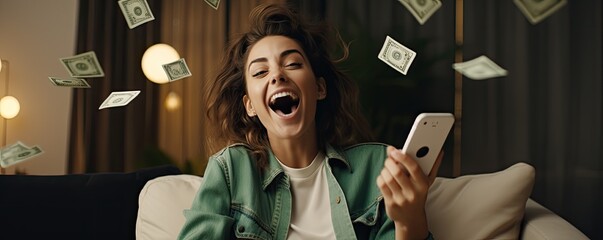 Beautiful young woman is lucky while using smartphone. Winning money concept - obrazy, fototapety, plakaty