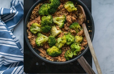 Chicken breast with brown rice and broccoli. Healthy fitness meal in a skillet
